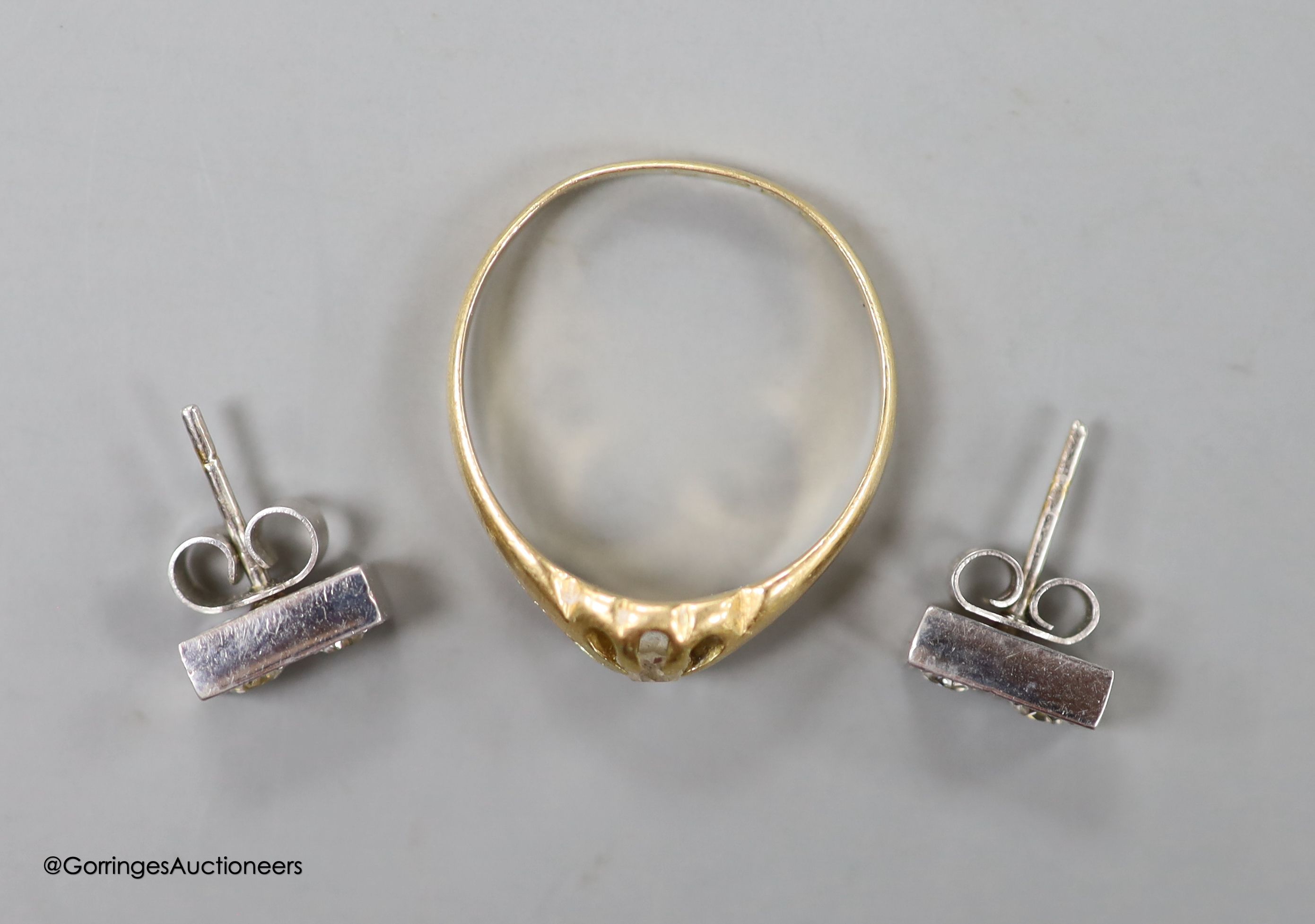 A pair of diamond and 18ct white gold earrings and a diamond solitaire ring, 18ct gold shank, gross 5.6 grams.